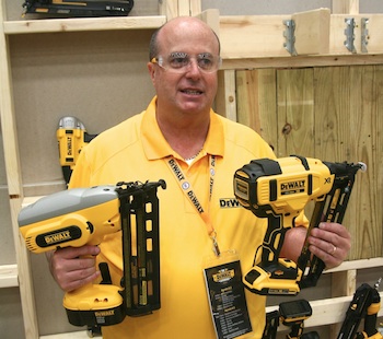 Product Manager Jorge Silveira shows off the size difference between previous (left) and new generation nailers (right). 