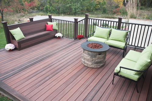 This photo shows the CAMO Hidden Deck Fastening System used with TAMKO EverGrain Envision decking in Shaded Auburn with Rustic Walnut accent and Marquee Railing in Dark Walnut with Weathered Copper accessories. This photo shows the CAMO Hidden Deck Fastening System used with TAMKO EverGrain Envision decking in Shaded Auburn with Rustic Walnut accent and Marquee Railing in Dark Walnut with Weathered Copper accessories.