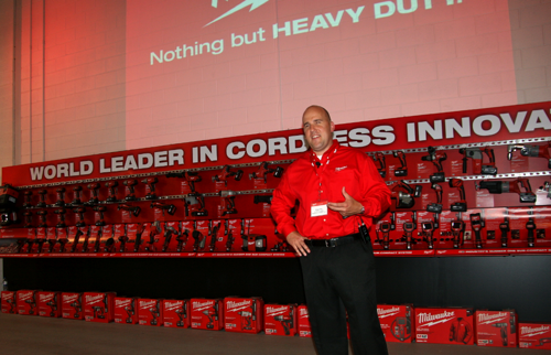 Milwaukee's Paul Fry speaks with trade press in front of the company's wall-o-cordless tools. Milwaukee's Paul Fry speaks with trade press in front of the company's wall-o-cordless tools. ,