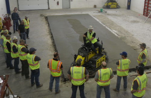 Bryan Birdwell, 17-time golden trowel award winner, works with students at the Wacker Neuson Technical Academy.  Birdwell and Wacker Neuson have partnered to offer concrete contractors a comprehensive training course to prepare for the ACI Specialty Commercial/Industrial Floor Finishers Certification test.  The March 2011 class achieved a slab rating of Ff152/FI 150 during their hands-on pour.