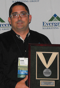 Kirk Burzynski of Jim & Slim's Tool Supply, Largo, FL accepts the Evergreen Marketing Group's Tier 3 Distributor of the Year award. Kirk Burzynski of Jim & Slim's Tool Supply, Largo, FL accepts the Evergreen Marketing Group's Tier 3 Distributor of the Year award.