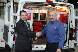 Rob Gutierrez (L), NTEA director of trade shows and events congratulates Jeff Kotz, Weather Guard senior product manager on Knaack's 2012 Editor's Choice Award at the Work Truck Show.