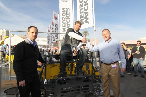 Lee Hadenfeldt, winner of Wacker Neuson&rsquo;s 2010 TROWEL CHALLENGETM competition at the World of Concrete, celebrates his victory on his new customized CRT 48-35VX ride-on trowel powered by a special VanguardTM BIG BLOCKTM V-twin engine.  Celebrating with Hadenfeldt is Dan Roche (left), marketing manager-commercial power at Briggs & Stratton, and Johannes Schulze Vohren, vice president of sale and product support for Wacker Neuson Corporation